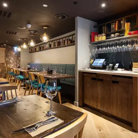 Stylish dining area at Zizzi Cardiff St David's with modern decor and natural accents.
