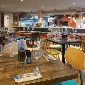 Stylish dining area at Zizzi Cardiff St David's with modern decor and natural accents.