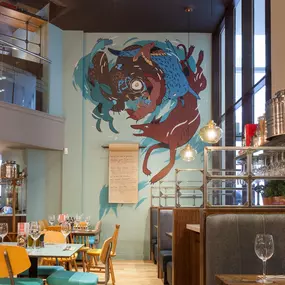Stylish dining area at Zizzi Cardiff St David's with modern decor and natural accents.