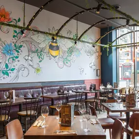 Stylish dining area at Zizzi Manchester Piccadilly with modern decor and natural accents.