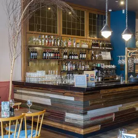 Stylish dining area at Zizzi Manchester Piccadilly with modern decor and natural accents.