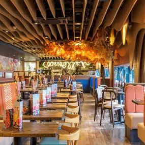 Zizzi Bankside, a rustic-modern interior with warm lighting.