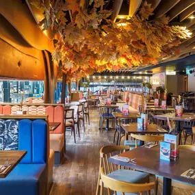 Zizzi Bankside, a rustic-modern interior with warm lighting.