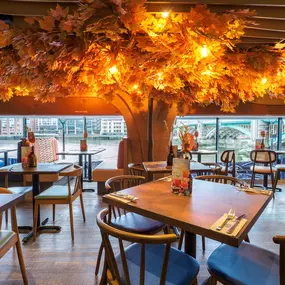 Zizzi Bankside, a rustic-modern interior with warm lighting.