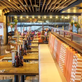 Zizzi Bankside, a rustic-modern interior with warm lighting.
