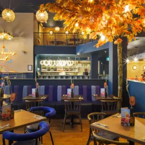 Stylish dining area at Zizzi Newcastle with modern decor and natural accents.