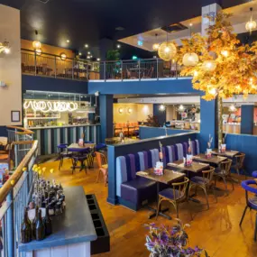 Stylish dining area at Zizzi Newcastle with modern decor and natural accents.