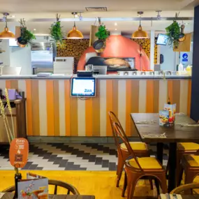 Stylish dining area at Zizzi Newcastle with modern decor and natural accents.
