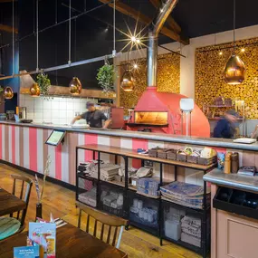 Zizzi Guildford, vibrant dining with oversized foliage art and open layout.