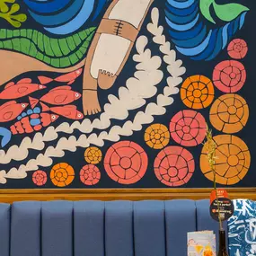 Zizzi Guildford, vibrant dining with oversized foliage art and open layout.