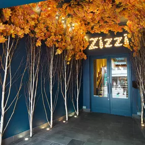 Zizzi Guildford, featuring dark-painted frontage, vibrant orange foliage and Zizzi's iconic signage.