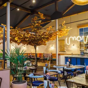 Zizzi Guildford, vibrant dining with oversized foliage art and open layout.