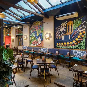 Zizzi Guildford, vibrant dining with oversized foliage art and open layout.