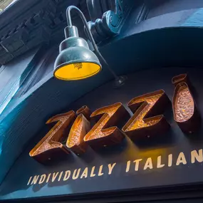 Zizzi Exeter exterior view of Zizzi's traditional dark toned frontage and iconic signage.