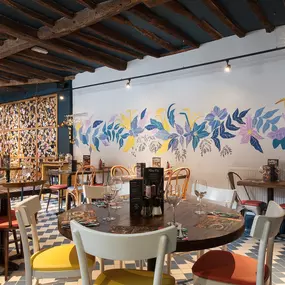 Interior of Zizzi Henley with wooden beams and warm, rustic décor.