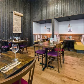 Stylish dining area at Zizzi Bradford with modern decor and natural accents.