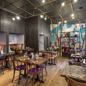 Stylish dining area at Zizzi Bradford with modern decor and natural accents.