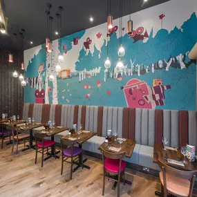 Stylish dining area at Zizzi Bradford with modern decor and natural accents.