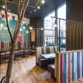 Stylish dining area at Zizzi Bradford with modern decor and natural accents.