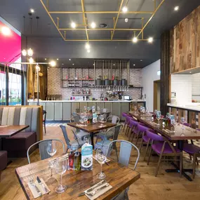 Stylish dining area at Zizzi Bradford with modern decor and natural accents.