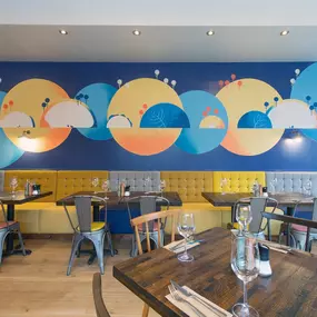 Stylish dining area at Zizzi Sevenoaks with modern decor and natural accents.