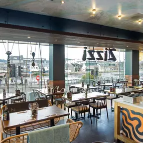 Zizzi Inverness, open-plan dining with full-height windows overlooking the River Ness.