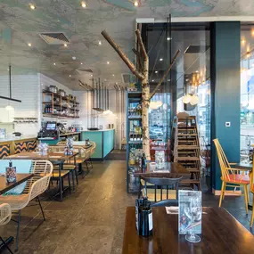 Zizzi Inverness, open-plan dining with full-height windows overlooking the River Ness.