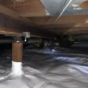 Crawl space with supports installed to fix sinking or sagging floors.