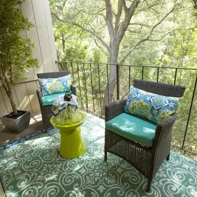 Model Apartment patio with wicker chairs and a table