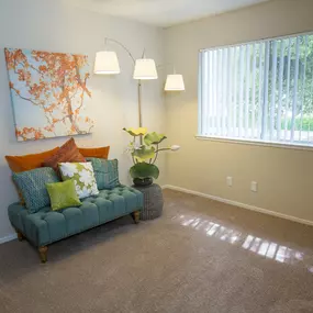 Model living room with a couch and a window