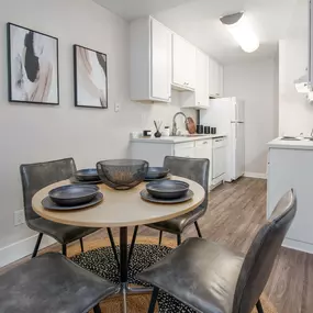 Model Apartment dining room with a table and chairs and a kitchen