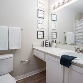 Model apartment spare bathroom with a sink and a toilet and a mirror