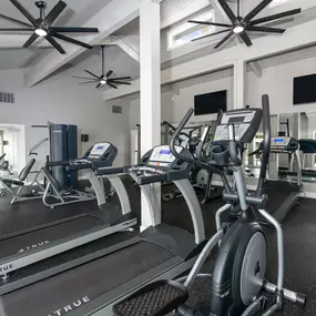 Fitness center with cardio equipment and televisions