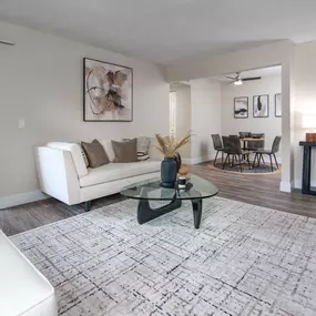 Model Apartment living room with a white couch and a glass coffee table