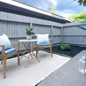 Model Apartment patio with two chairs and a table on a rug