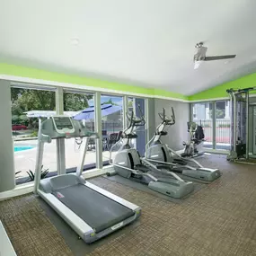 Fitness Center with cardio equipment and windows overlooking a pool