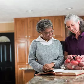 Caregiver assisting client with meal preparation