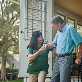 Care Pro assisting client on stairs