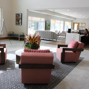 This welcoming reception area at Saint Therese of Corcoran features comfortable seating, a coffee table, and a large window that provides natural light.