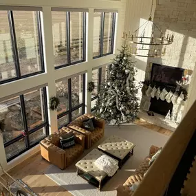 Manage bright sunlight in rooms with expansive windows using custom solar shades from GrandView Blinds & Designs. This high-ceiling great room demonstrates effective glare reduction and light filtering, protecting interiors while complementing the modern farmhouse aesthetic.