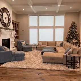 Complete your comfortable living space with custom cellular shades from GrandView Blinds & Designs. This transitional family room features light-filtering shades that provide privacy and complement the large windows and coffered ceiling detail.