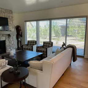 Balance natural light, privacy, and your outdoor view with custom banded (zebra) shades from GrandView Blinds & Designs. These versatile, modern shades enhance this living room by allowing adjustable light filtering while preserving the connection to the outside.
