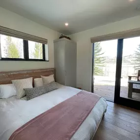 Add privacy and filtered light to bedrooms with custom Roman shades from GrandView Blinds & Designs, perfectly suited for high horizontal or transom-style windows above the bed.