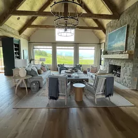 Control light and maintain stunning views in your great room with custom roller or solar shades from GrandView Blinds & Designs. These sleek shades complement the modern rustic architecture, including vaulted wood ceilings and beams, while reducing glare.
