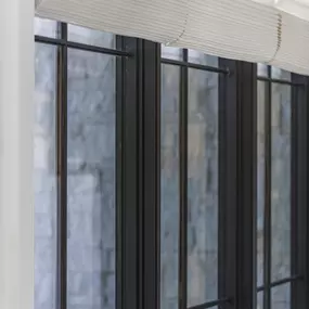 Discover the detailed craftsmanship of Roman shades from GrandView Blinds & Design. Providing a soft, layered look, these shades offer precise light control and timeless style for any window.