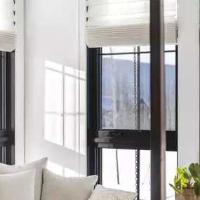 Create a serene bedroom retreat with elegant Roman shades from GrandView Blinds & Design. These custom window treatments offer adjustable light filtering and privacy for ultimate comfort.