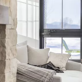Complete your comfortable space with beautiful Roman shades from GrandView Blinds & Design. These custom window treatments provide perfect light control and a soft aesthetic next to your favorite seating spot.