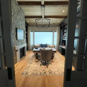 Enhance your home office with versatile layered window treatments from GrandView Blinds & Designs. This traditional study showcases custom drapery over sheers, offering flexible light control and privacy for a productive and elegant workspace.