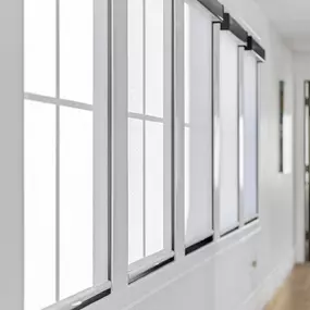 Dress multiple windows with sleek and functional roller shades from GrandView Blinds & Design. Ideal for hallways and large window expanses, providing consistent style and light control.