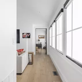 Outfit your hallway or living space with sleek roller shades from GrandView Blinds & Design. These custom window treatments offer a clean look and effective light management for multiple windows.